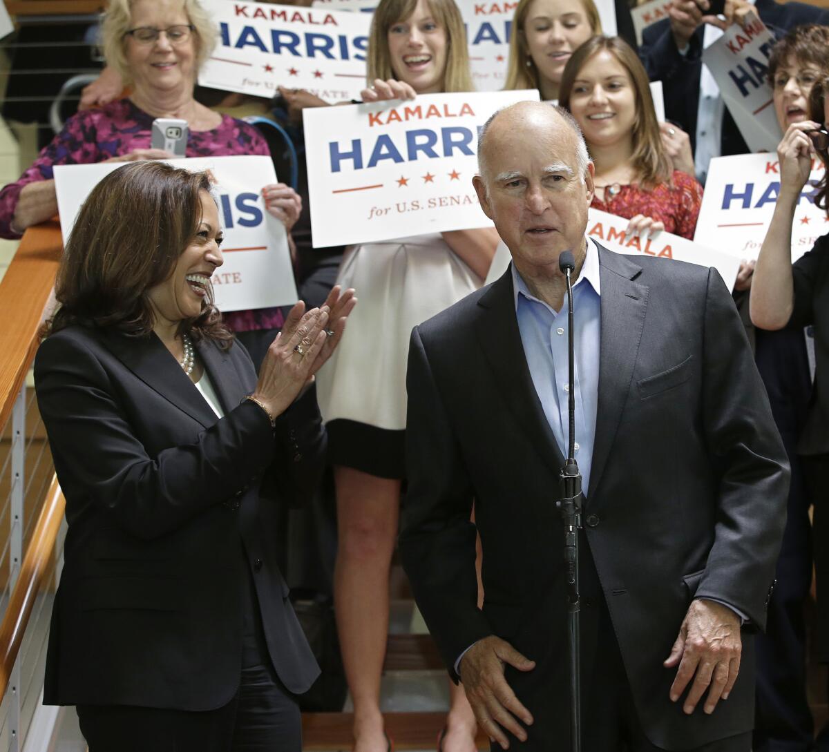 State Atty. Gen. Kamala Harris smiles and claps as Gov. Jerry Brown endorses her for the U.S. Senate.