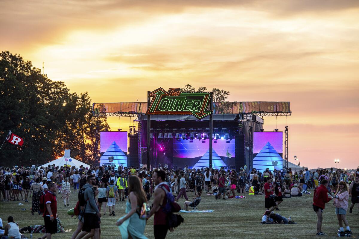 Concert-goers mingle near a festival stage in Tennessee