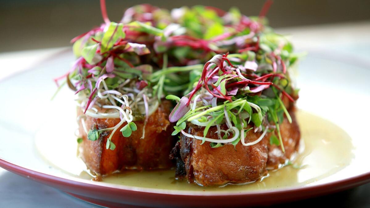 Chicharron with elephant garlic mojo, radish sprout and picked herbs from Broken Spanish.