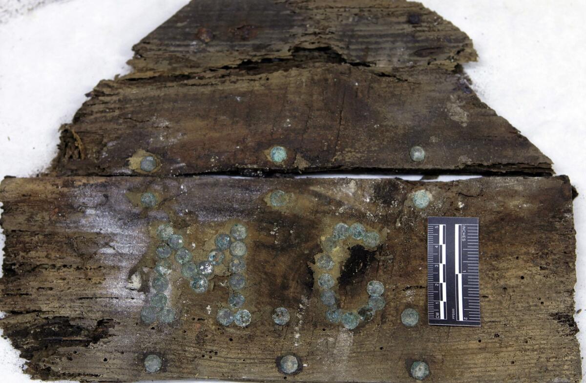 The initials "M.C" on a newly discovered coffin fragment found in a Spanish crypt. Could it hold the bones of Miguel de Cervantes?