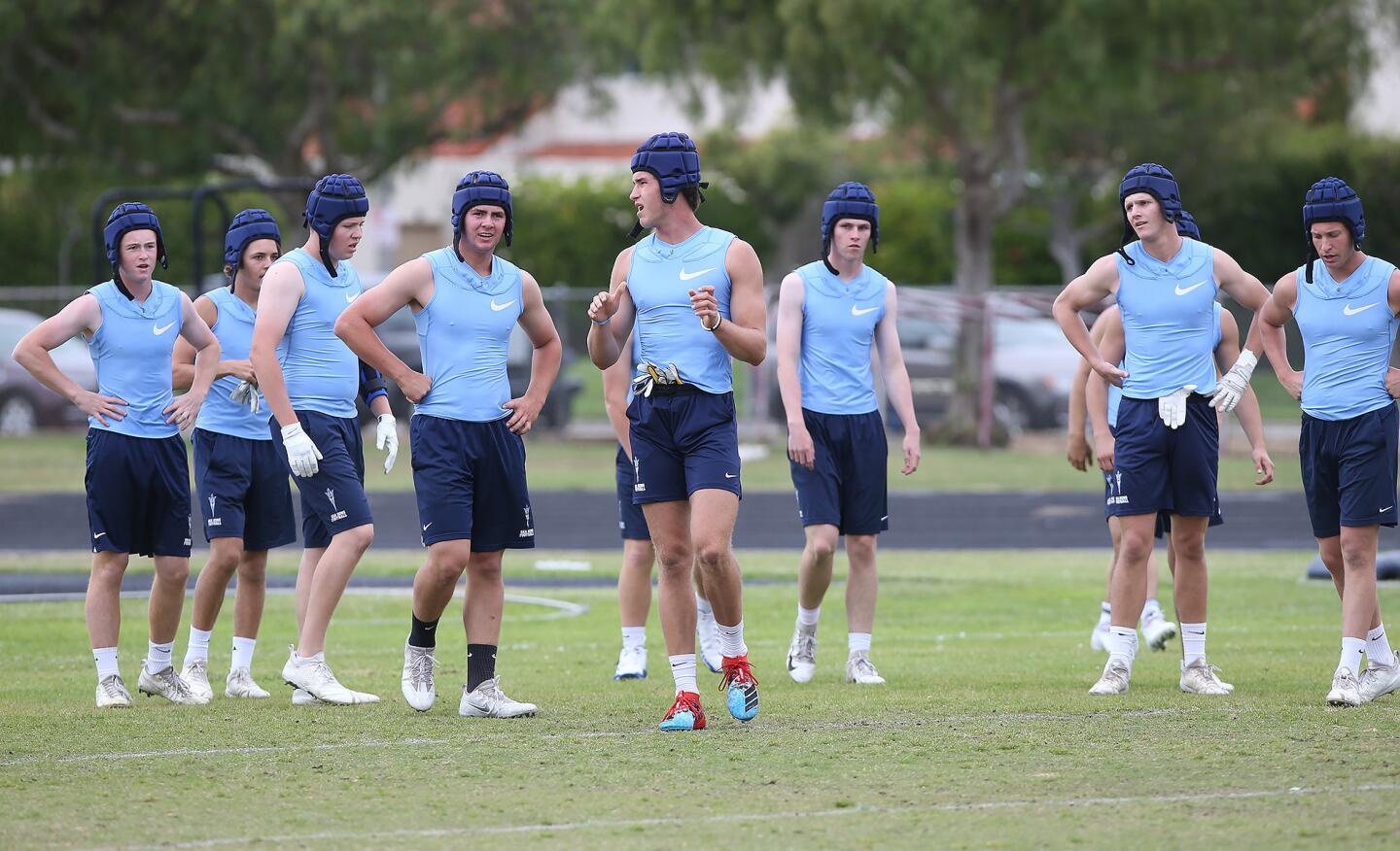 Reciever John Humphreys, center, gathers the team together during a spring football showcase at Corona del Mar High on Wednesday.