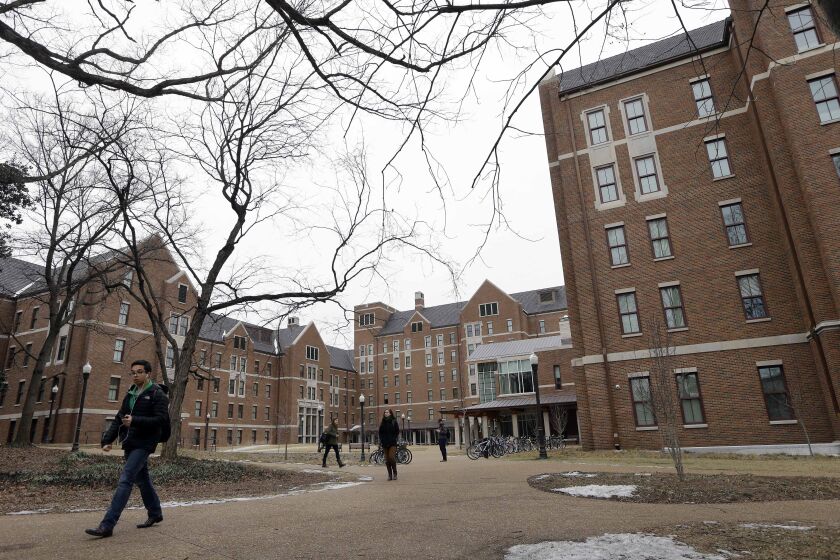 In this Feb. 24, 2015 photo, students walk through the Warren College and Moore College area at Vanderbilt University on Tuesday, Feb. 24, 2015, in Nashville, Tenn. Vanderbilt is one of a small but growing number of U.S. colleges and universities that have embraced a "residential college" model where students become part of a close-knit but diverse community that enhances both their academic and social lives. (AP Photo/Mark Humphrey)