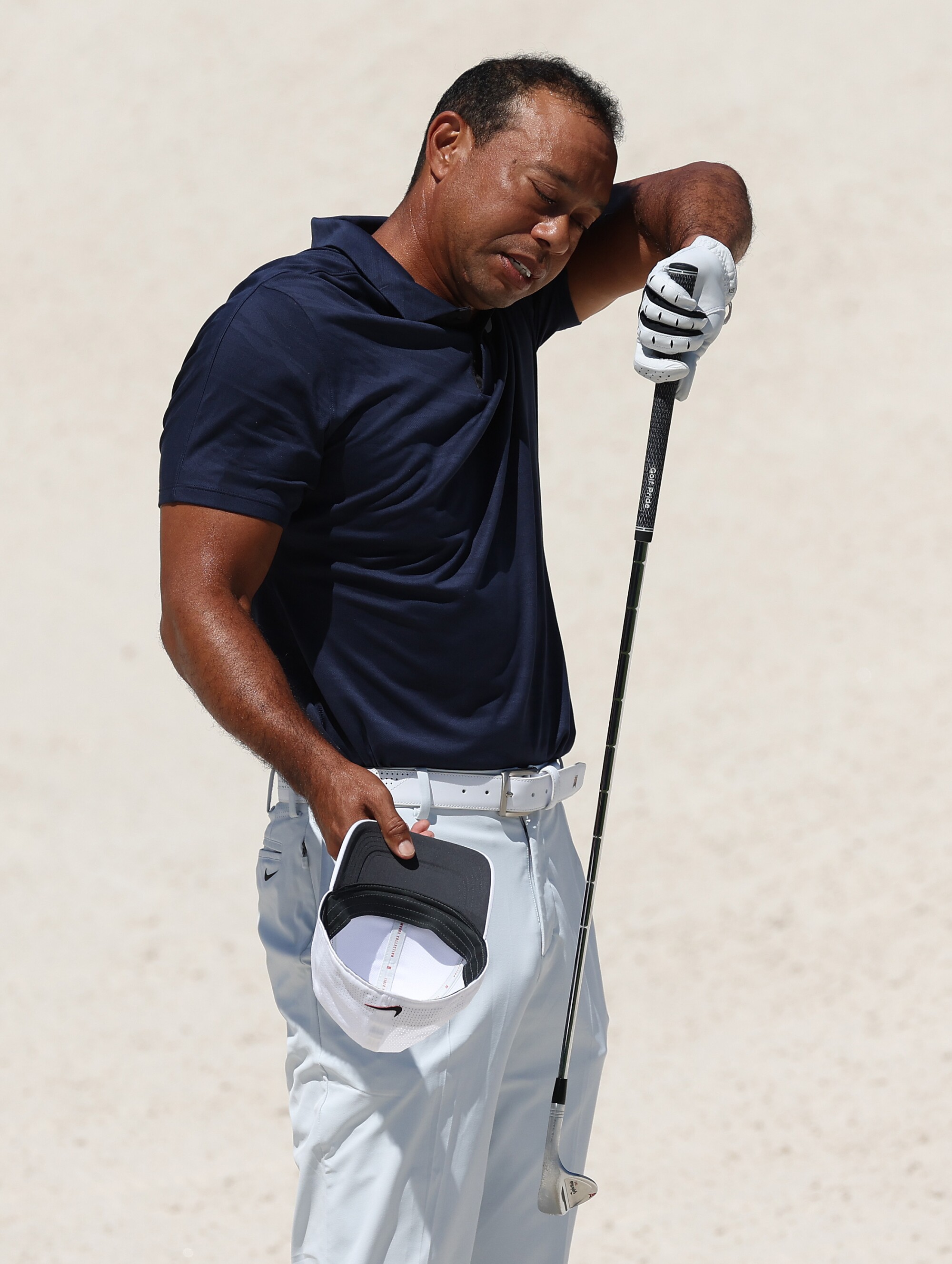 Tiger Woods wipes his face 