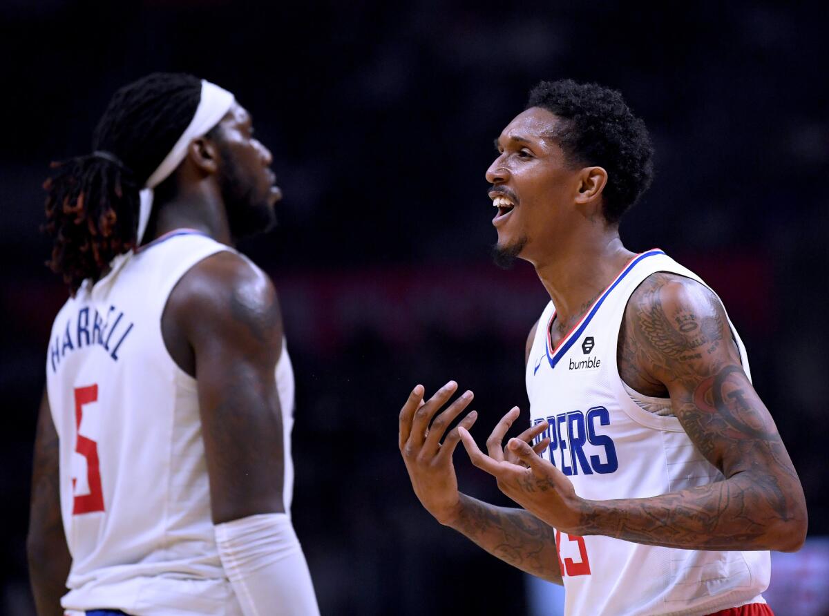Clippers guard Lou Williams reacts to a foul call alongside teammate Montrezl Harrell during a game against the Hawks last season.