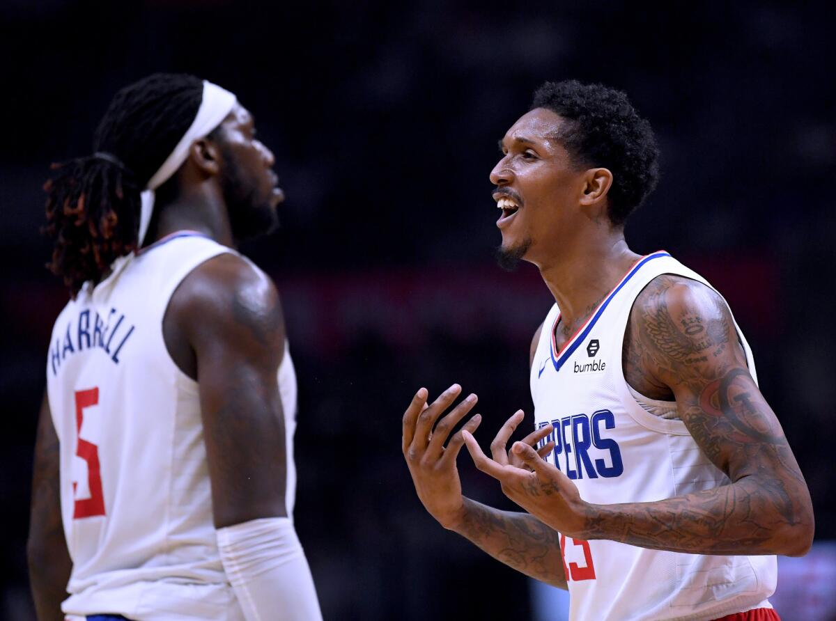 Clippers guard Lou Williams, right, reacts to a foul call alongside teammate Montrezl Harrell during a game against the Hawks on Jan. 28 at Staples Center.