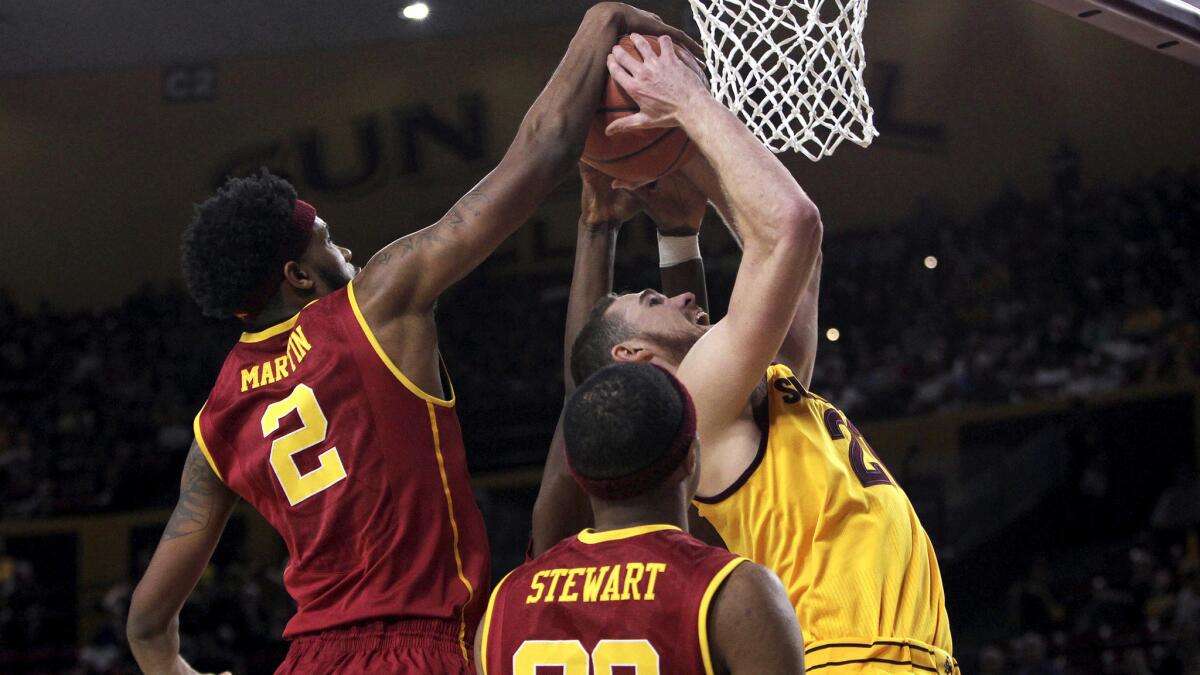 USC forward Malik Martin (2) blocks a shot by Arizona State center Eric Jacobsen during the first half Friday night.