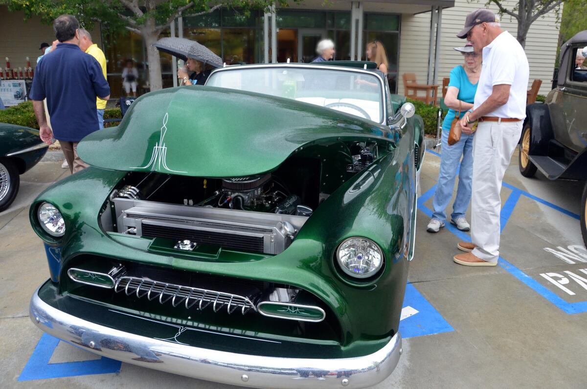 Ted Leventhal, right, describes his 1951 Chevrolet convertible during the OASIS Car Show, held Saturday in Newport Beach.