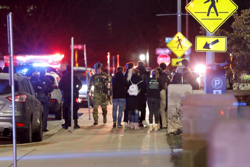 Students gather on the campus of Michigan State University after a shelter in place order was lifted early Tuesday, Feb. 14, 2023, in East Lansing, Mich. A gunman opened fire Monday night at Michigan State University, killing three people and wounding five more, before fatally shooting himself after an hours-long manhunt that forced frightened students to hide in the dark. (AP Photo/Al Goldis)