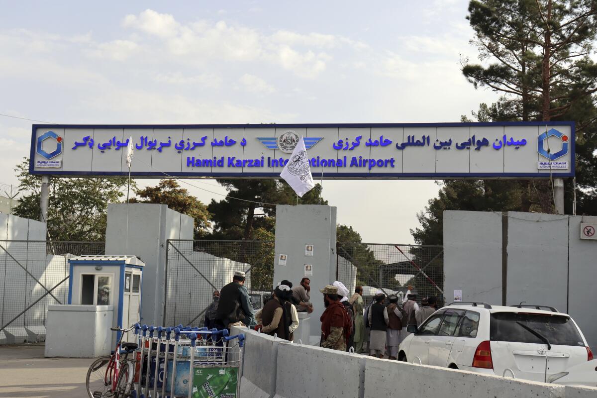 Taliban fighters standing guard at Kabul airport entrance