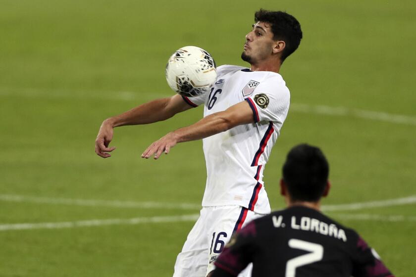 FILE - United States Johnny Cardoso, top, controls the ball during an Olympic qualifying soccer match against Mexico in Guadalajara, Mexico, March 24, 2021. Cardoso will miss the United States’ matches with Trinidad and Tobago that will determine a berth in next year’s Copa América and the CONCACAF Nations League semifinals. The Americans host Trinidad on Thursday, Nov. 16, 2023, and play at the Soca Warriors on Nov. 20. (AP Photo/Fernando Llano, File)