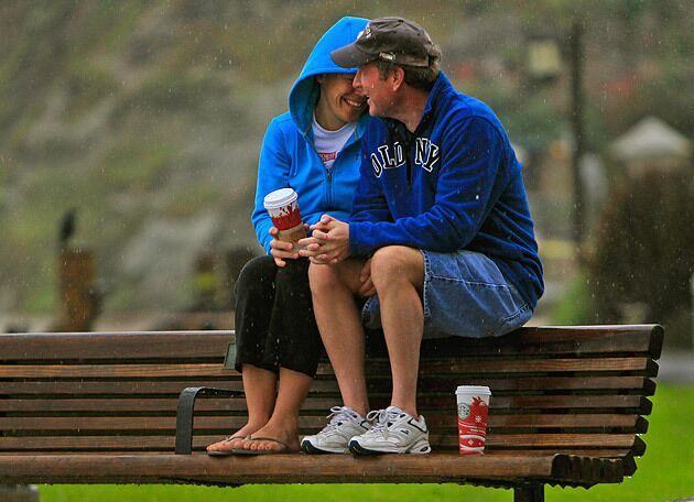 Sybil Penrose and Matt Meyer, visiting from Colorado, said they didn't even care that it was raining as they enjoyed a cup of coffee while perched on a bench at Laguna Beach's Main Beach. The couple said they were enjoying the last day of their vacation in California and kind of liked the warmth of the rain, compared with the frigid temperatures of Colorado. See full story