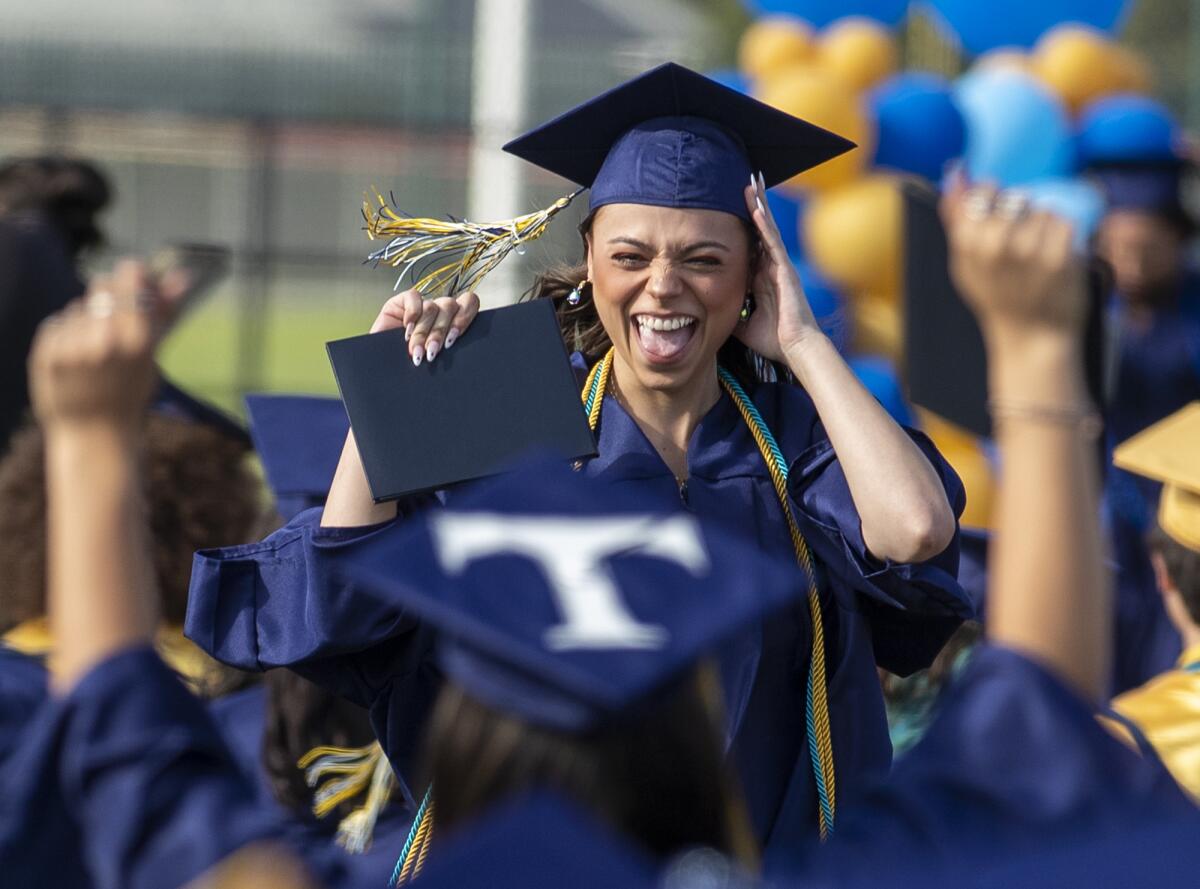 Marina High graduate Cassidy Hughes celebrates after receiving her diploma on Thursday.
