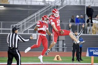 Mark Bowman (19) celebrates with Marcus Harris after after scoring Mater Dei’s first touchdown against San Mateo Serra.