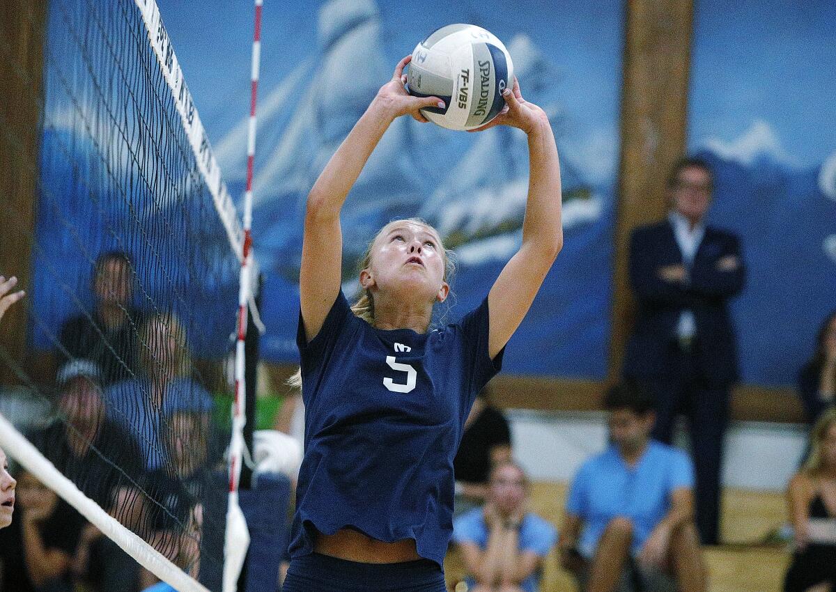 Newport Harbor's Tegan Glenn sets the ball at the net for a kill attempt against Corona del Mar in a Sunset Conference crossover match at home on Thursday.