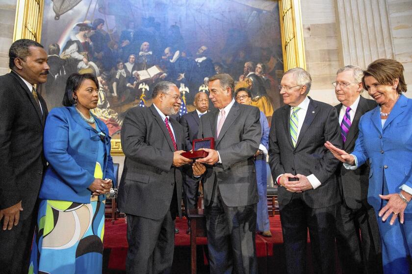House Speaker John A. Boehner presents Lonnie Bunch, founding director of the Smithsonian National Museum of African American History and Culture, the Congressional Gold Medal on behalf of the Rev. Martin Luther King Jr. and Coretta Scott King.
