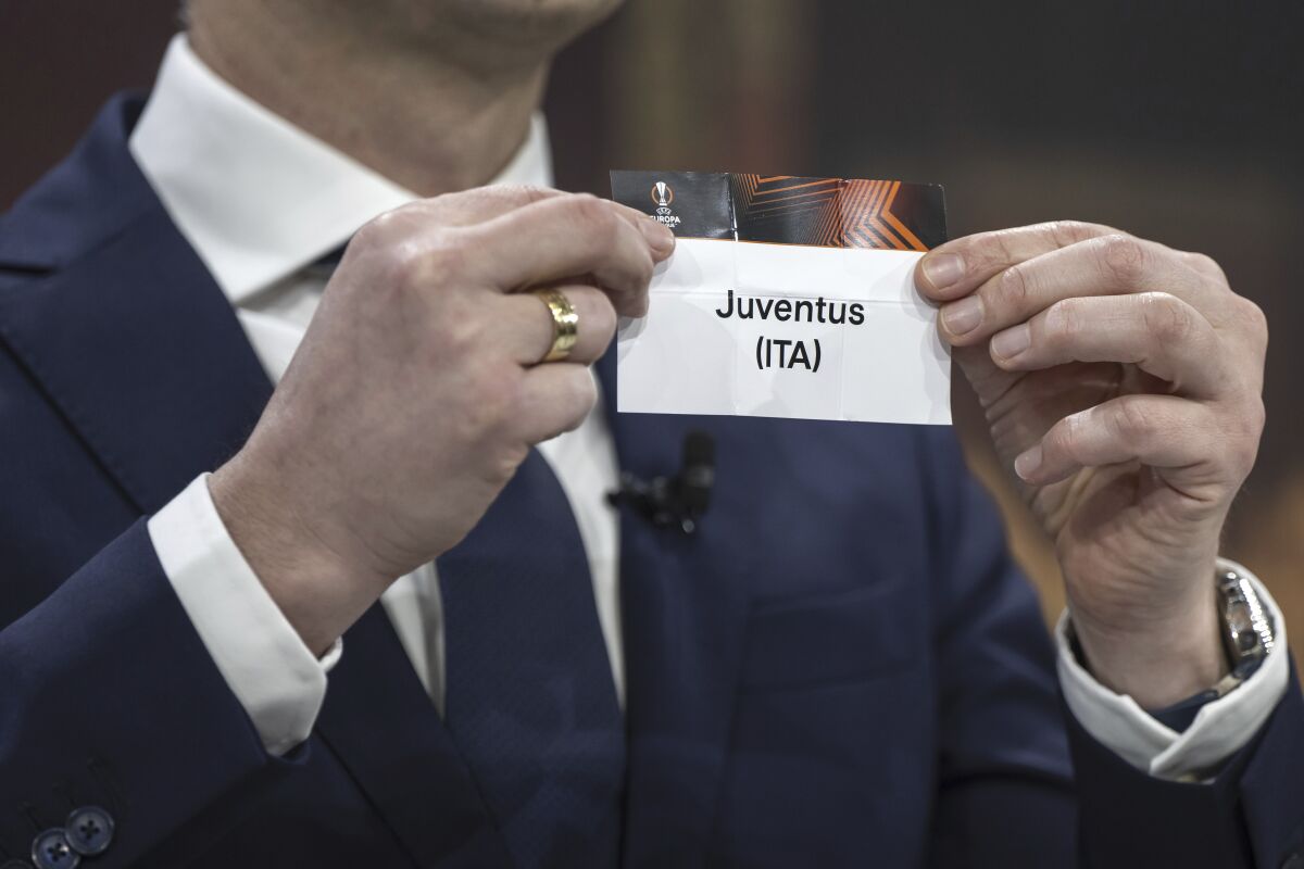Hungarian former player and ambassador for the UEFA Europa League final in Budapest Zoltan Gera shows a ticket of soccer club Juventus during the draw for the UEFA soccer Europa League quarter-finals at the UEFA Headquarters in Nyon, Switzerland, Friday, March 17, 2023. (Martial Trezzini/Keystone via AP)