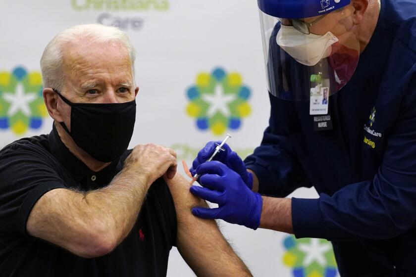 President-elect Joe Biden receives his second dose of the coronavirus vaccine at ChristianaCare Christiana Hospital in Newark, Del., Monday, Jan. 11, 2021. The vaccine is being administered by Chief Nurse Executive Ric Cuming. (AP Photo/Susan Walsh)