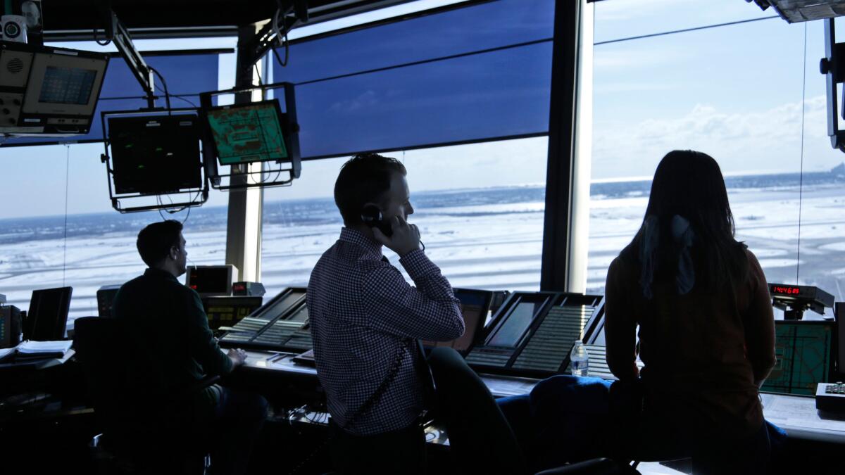Air traffic controllers work in the tower at JFK International Airport in New York.