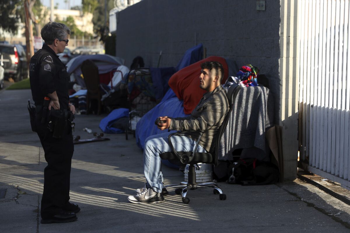 Det. Shannon Geaney talks with a homeless man