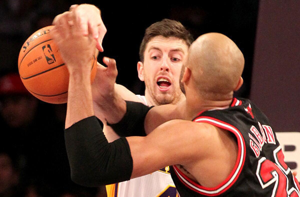 Lakers forward Ryan Kelly strips the ball from Bulls forward Taj Gibson in the first quarter Sunday at Staples Center.