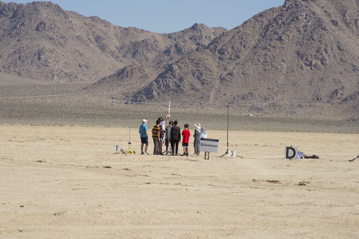 Ivy Max members prepare their rocket for launch.