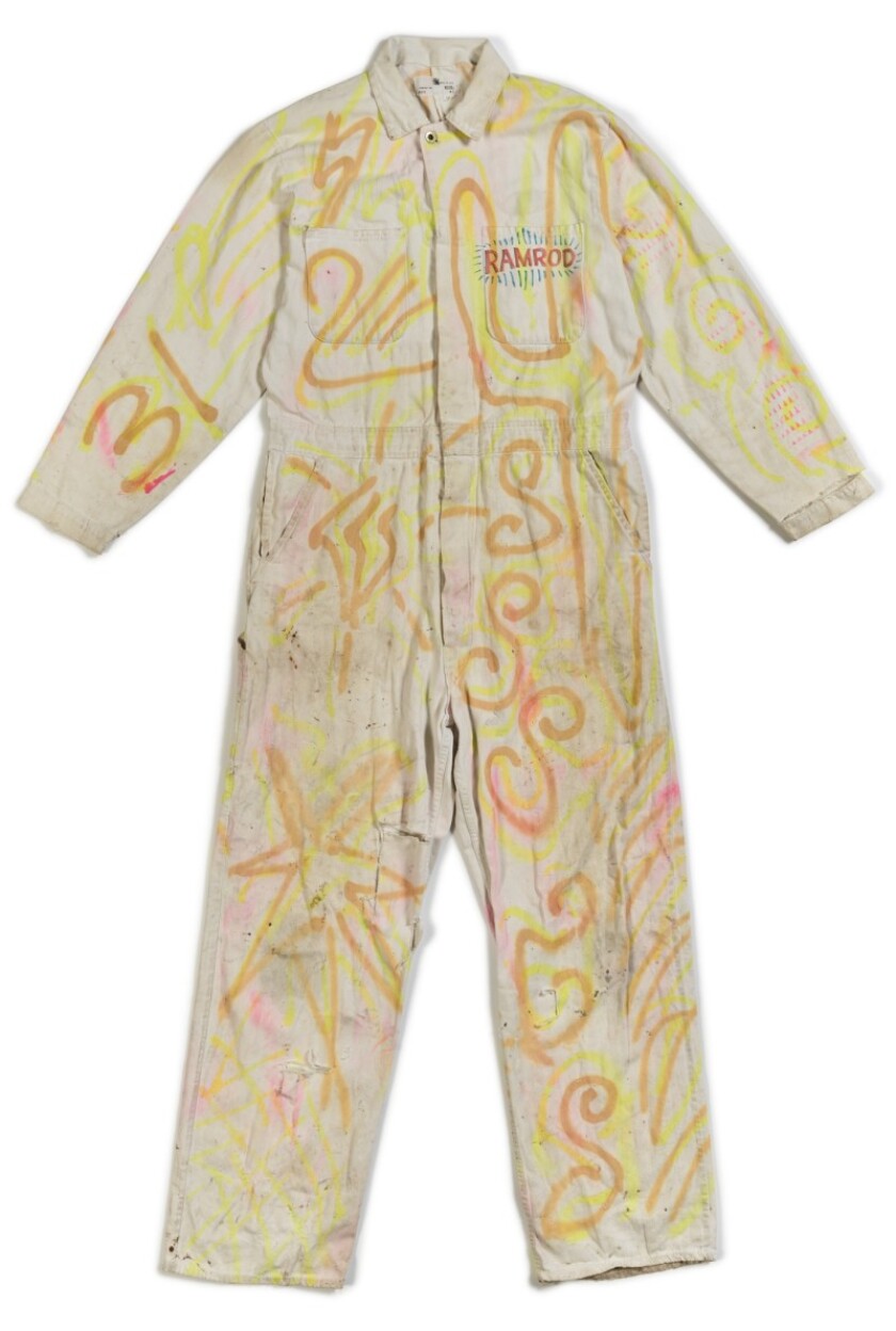 A jumpsuit with squiggly drawings on it