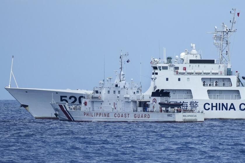 A Chinese Coast Guard ship with bow number 5201 blocks Philippine Coast Guard ship BRP Malapascua as it maneuvers to enter the mouth of the Second Thomas Shoal locally known as Ayungin Shoal at the South China Sea on Sunday, April 23, 2023. The near-collision was among the tense confrontations encountered by two Philippine government vessels against China, which undertook a weeklong voyage in one of the world's most hotly contested sea passages to assert Philippine sovereignty. (AP Photo/Aaron Favila)