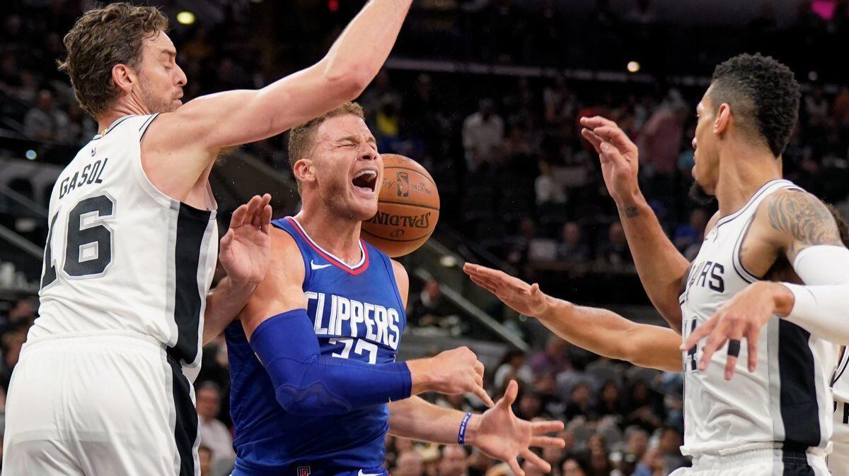 Clippers forward Blake Griffin, center, tangles with San Antonio Spurs' Pau Gasol, left, and Danny Green during the first half on Tuesday.