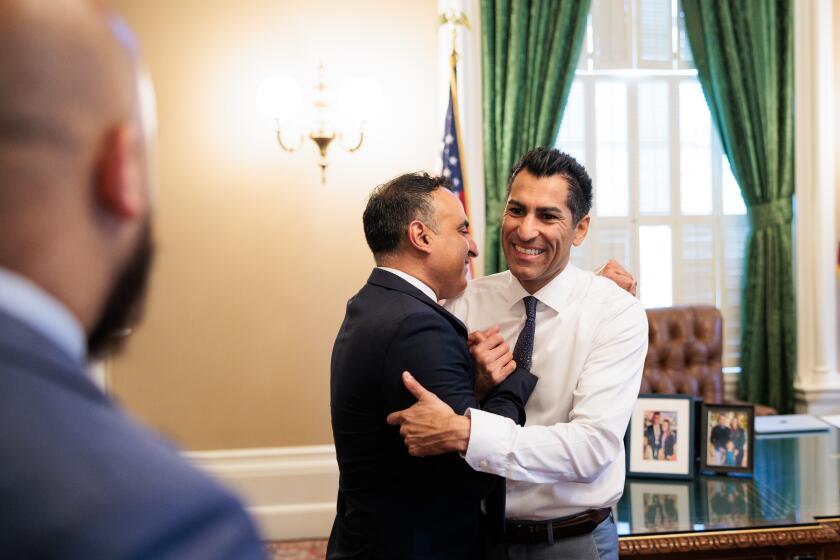 SACRAMENTO CA JUNE 30, 2023 - Assemblymember Robert Rivas, right, embraces Assemblymember Ash Kalra in the Speaker's Office before he's sworn in as Assembly Speaker at the State Capitol in Sacramento, California on June 30, 2023. (Max Whittaker / For The Times)
