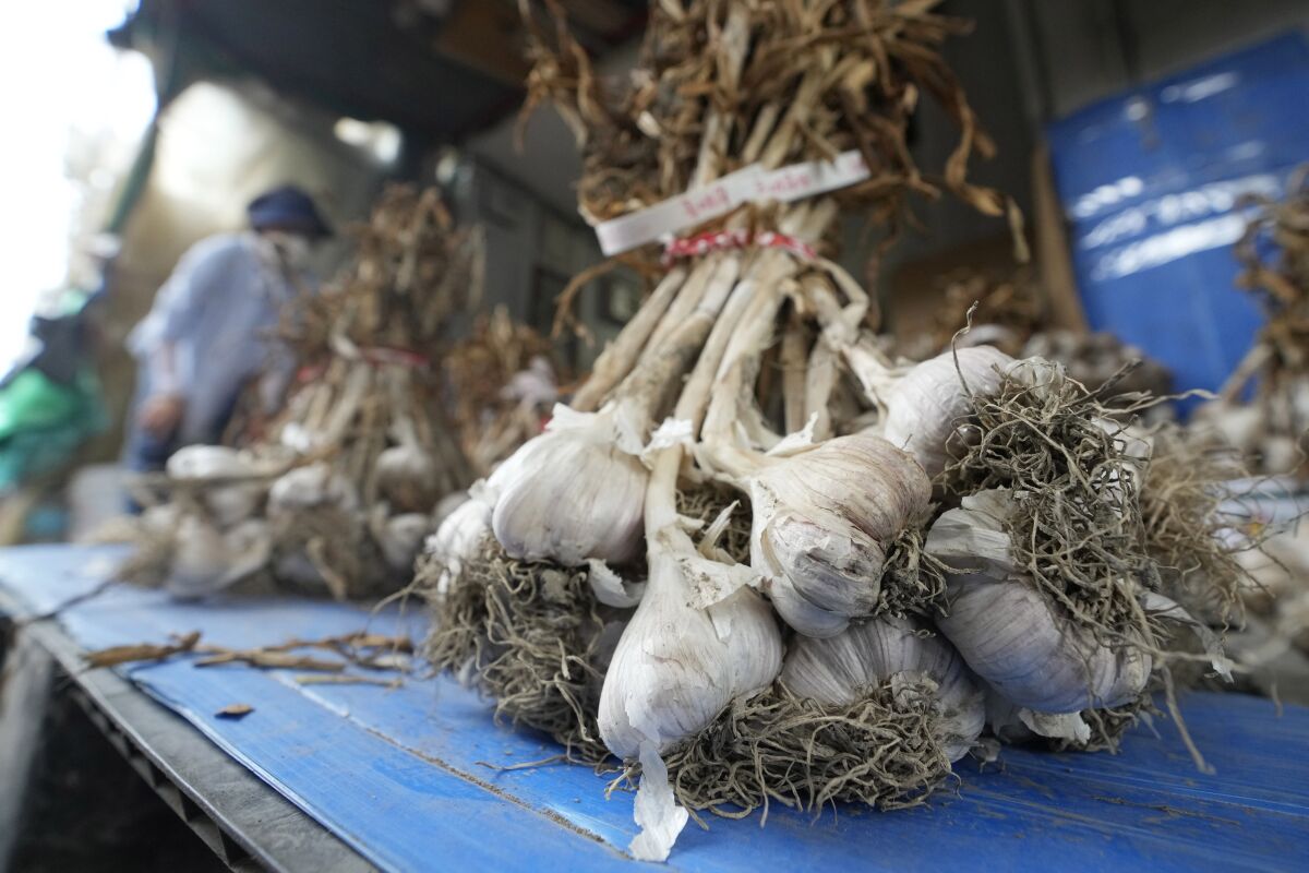 Bulbs of garlic are displayed at a shop in a traditional market in Seoul, South Korea, Wednesday, Aug. 3, 2022. A rural South Korean town is hot water over its video ad on garlic that some farmers say is obscene and has even sexually objectified the agricultural product. (AP Photo/Ahn Young-joon)