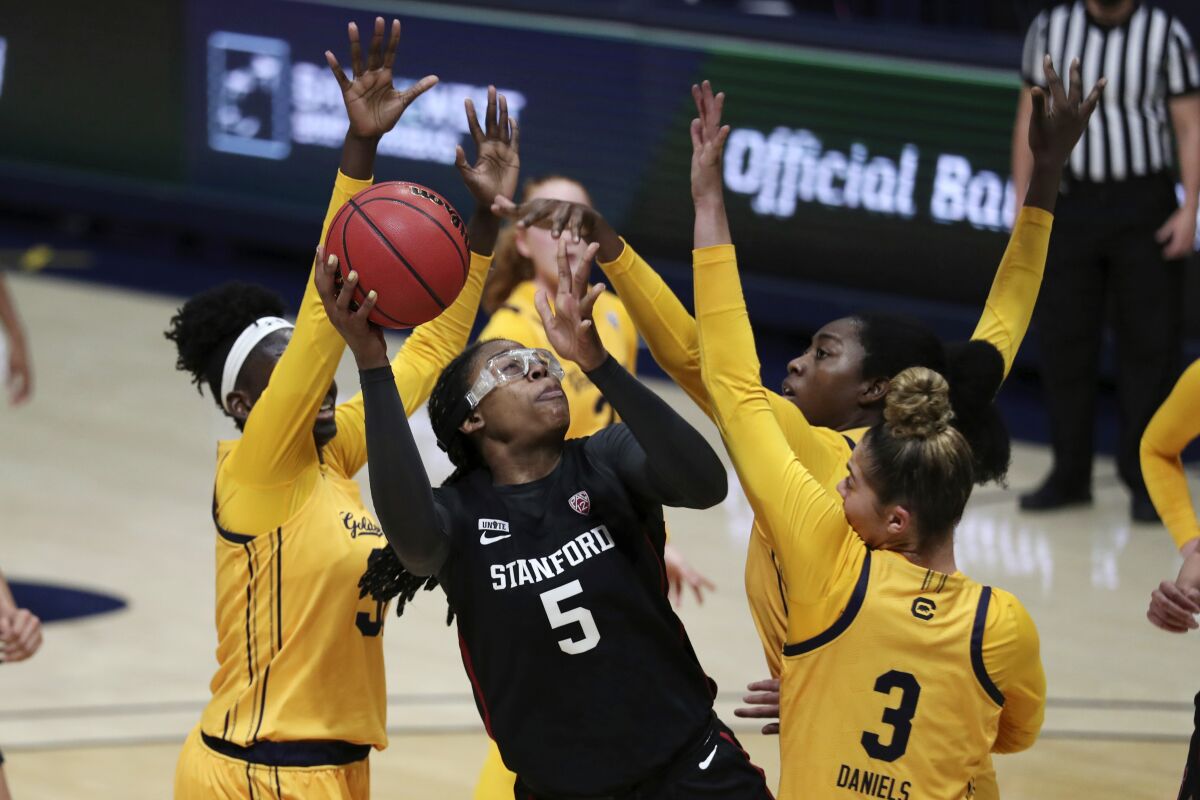 Stanford's Francesca Belibi (5) drives against California's Fatou Samb (33) and Dalayah Daniels (3) during the first half of an NCAA college basketball game Sunday, Dec. 13, 2020, in Berkeley, Calif. (AP Photo/Jed Jacobsohn)