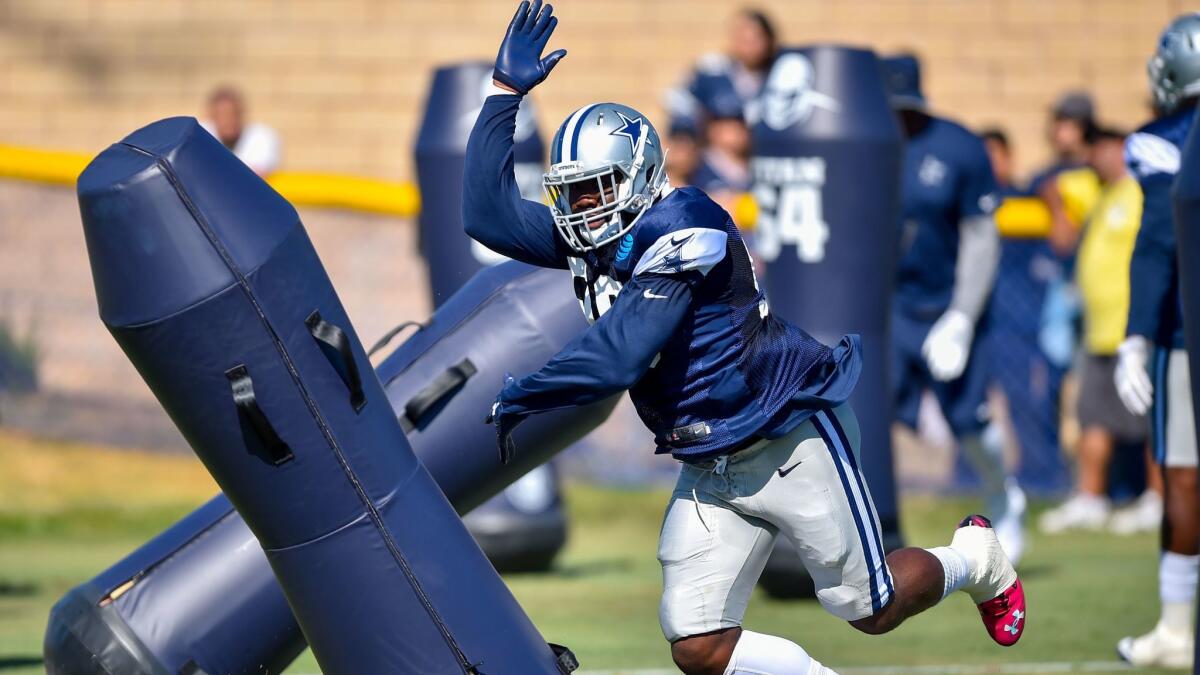 Cowboy defensive end Charles Tapper runs a pass rushing drill in Oxnard. (Gus Ruelas / Associated Press)