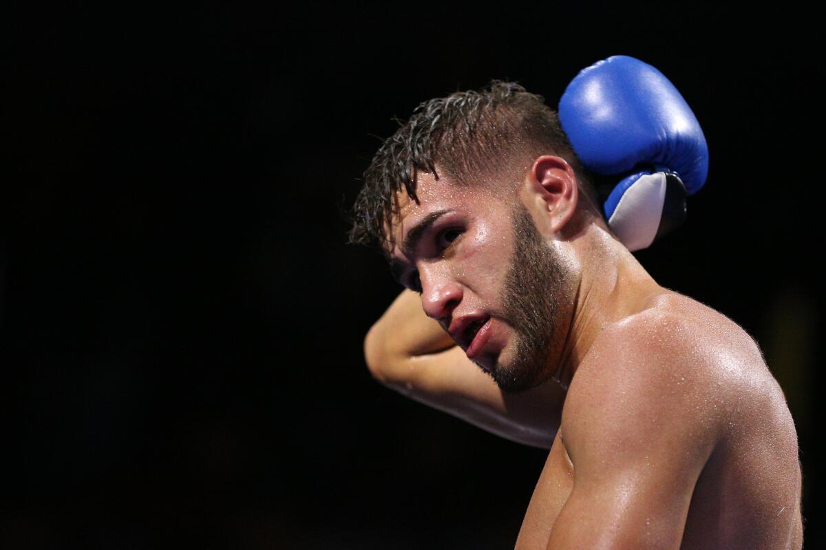 Prichard Colon holds the back of his head during a fight against Terrel Williams in their super-welterweight bout in Fairfax, Va., on Oct. 17.