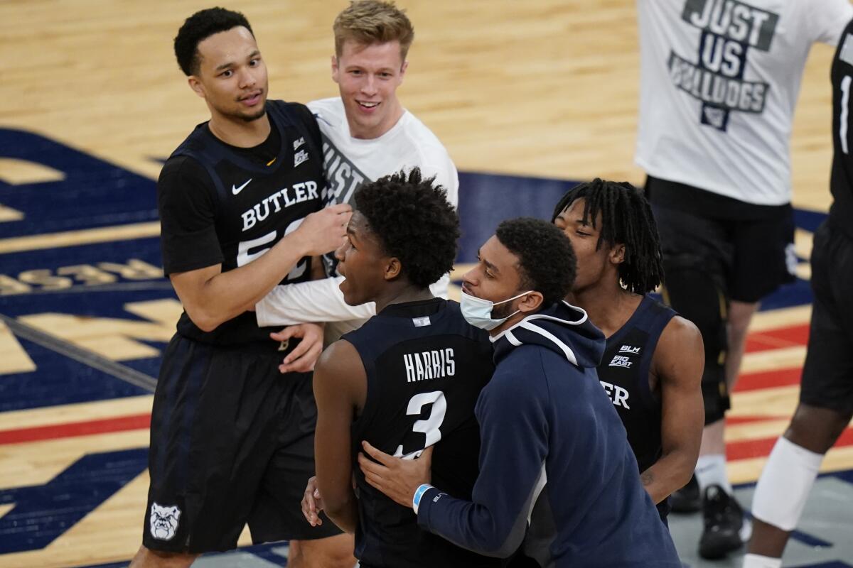 Butler's Chuck Harris (3) celebrates with teammates after an NCAA college basketball game against Xavier in the Big East conference tournament Wednesday, March 10, 2021, in New York. Butler won 70-69. (AP Photo/Frank Franklin II)