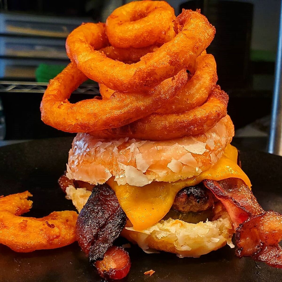 Yes, that burger is sitting inside a doughnut and topped with onion rings. Find it at Louisiana Purchase.