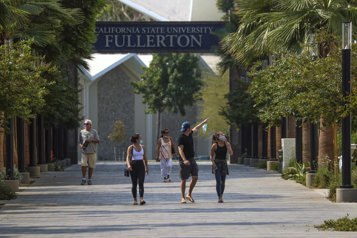 Students walk beneath a Cal State Fullerton banner. 