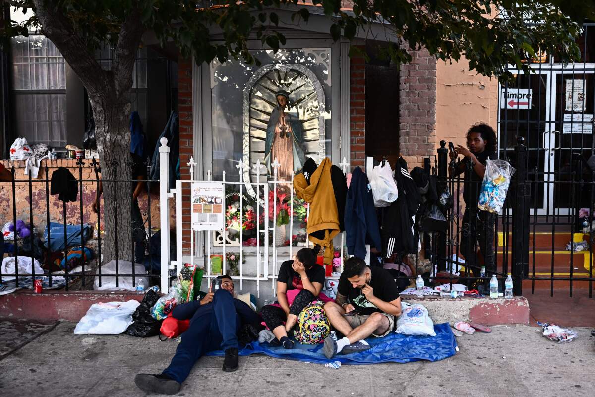 Migrants camp outside the Sacred Heart Church in downtown El Paso