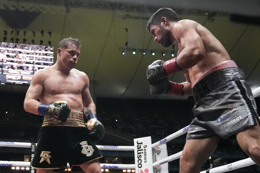 Saul "Canelo" Alvarez of Mexico, left, fights John Ryder of Britain in a super middleweight title boxing match at the Akron Stadium in Guadalajara, Mexico, Saturday, May 6, 2023. (AP Photo/Moises Castillo)