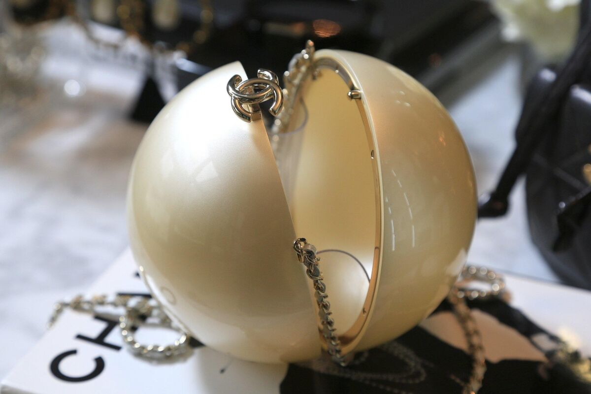 A Chanel, pearl shaped plexi-glass Minaudiere bag sells for $28,000 at the Designer Vault. — David Brooks