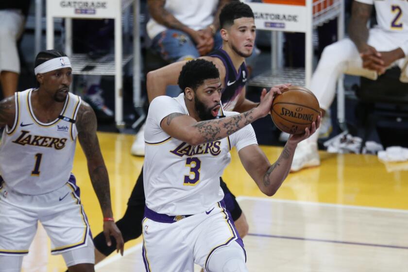 LOS ANGELES, CA - MAY 09: Los Angeles Lakers forward Anthony Davis (3) grabs a rebound against the Phoenix Suns.