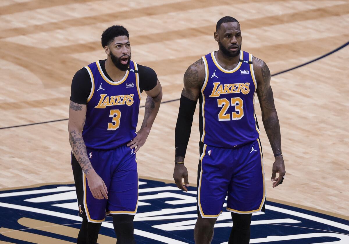 Lakers stars Anthony Davis, left, and LeBron James talk during a timeout against the New Orleans Pelicans.