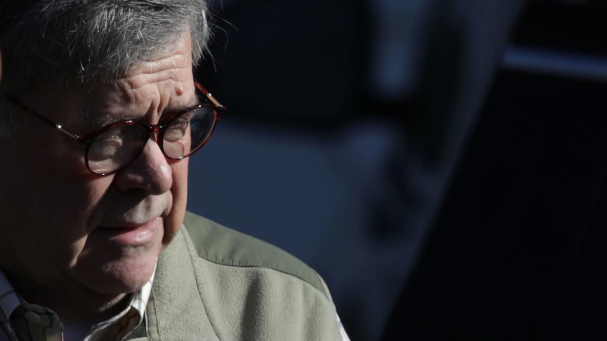 Atty. Gen. William P. Barr leaves his house Sunday. He spent the weekend at Justice Department headquarters in Washington.
