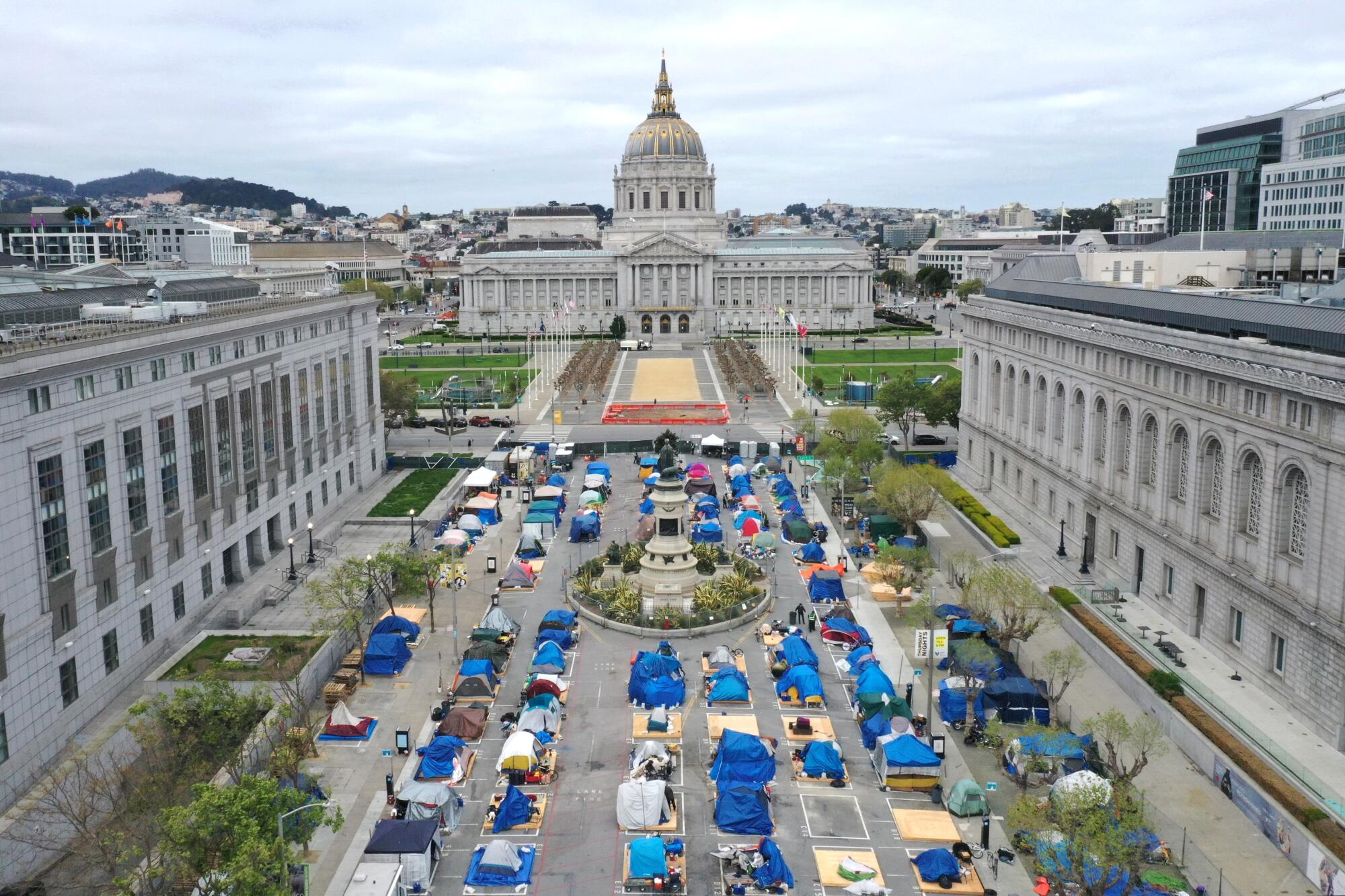 Rows of tents fill a plaza at a sanctioned homeless encampment in San Francisco.