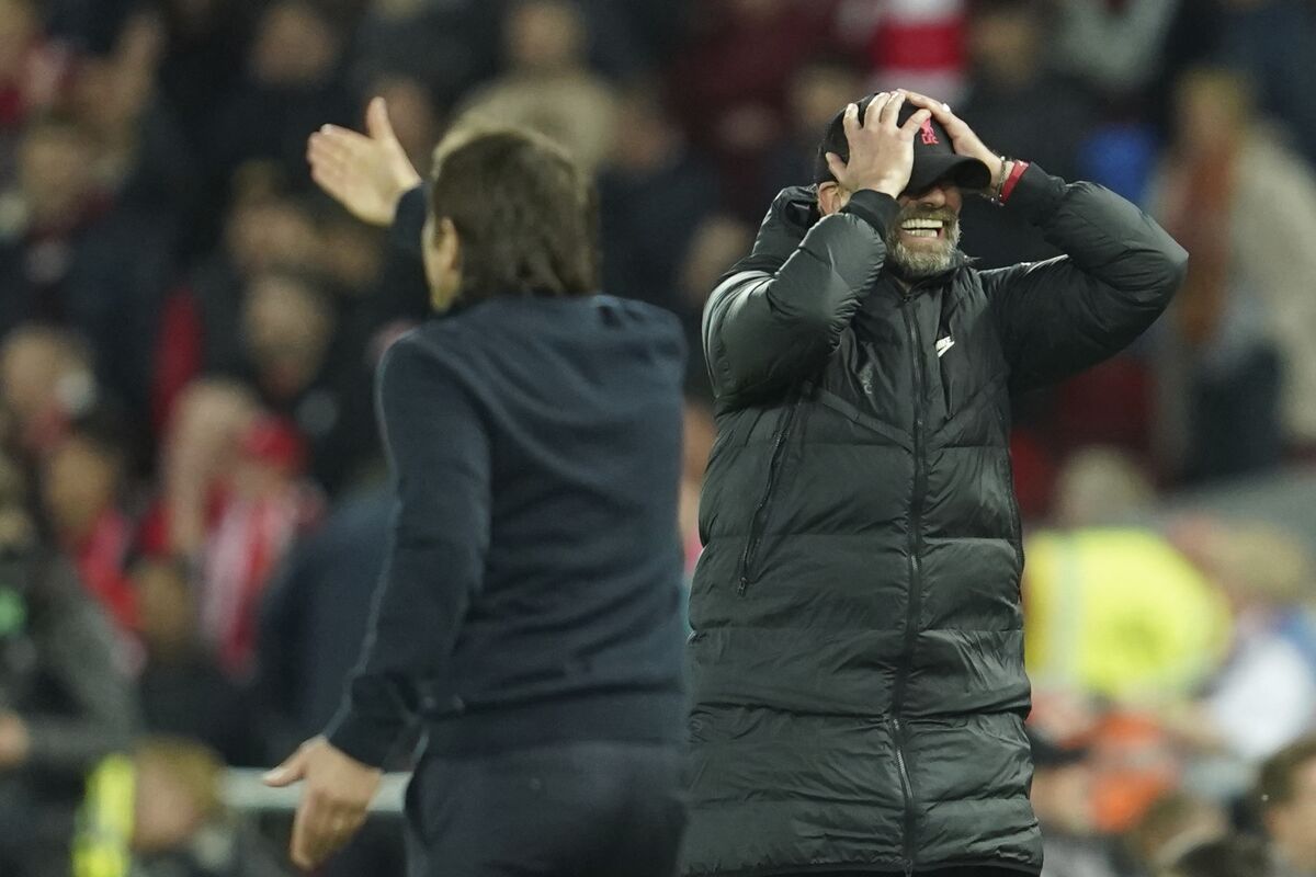 Liverpool's manager Jurgen Klopp, right, gestures during the English Premier League soccer match between Liverpool and Tottenham Hotspur at Anfield stadium in Liverpool, England, Saturday, May 7, 2022. (AP Photo/Jon Super)
