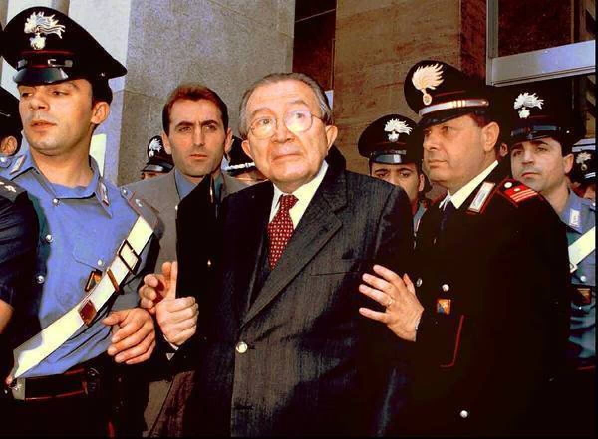Former Italian Prime Minister Giulio Andreotti, center, is shown leaving court in 1996. The seven-time prime minister dominated post-World War II politics, but was tainted by allegations of Mafia ties. Andreotti has died at age 94.