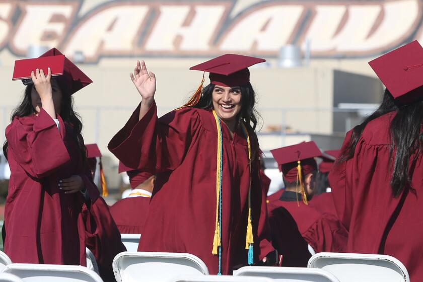 Nailea Hernandez, who graduated with honors, waves to family during the 2019 Ocean View High School commencement ceremony on Wednesday.
