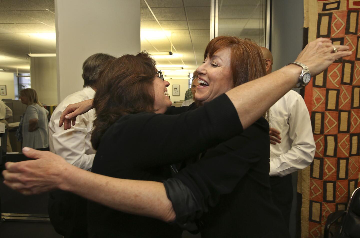 Times TV critic and culture editor Mary McNamara, left, and staff writer Diana Marcum celebrate their Pulitzer Prize wins in the newsroom.