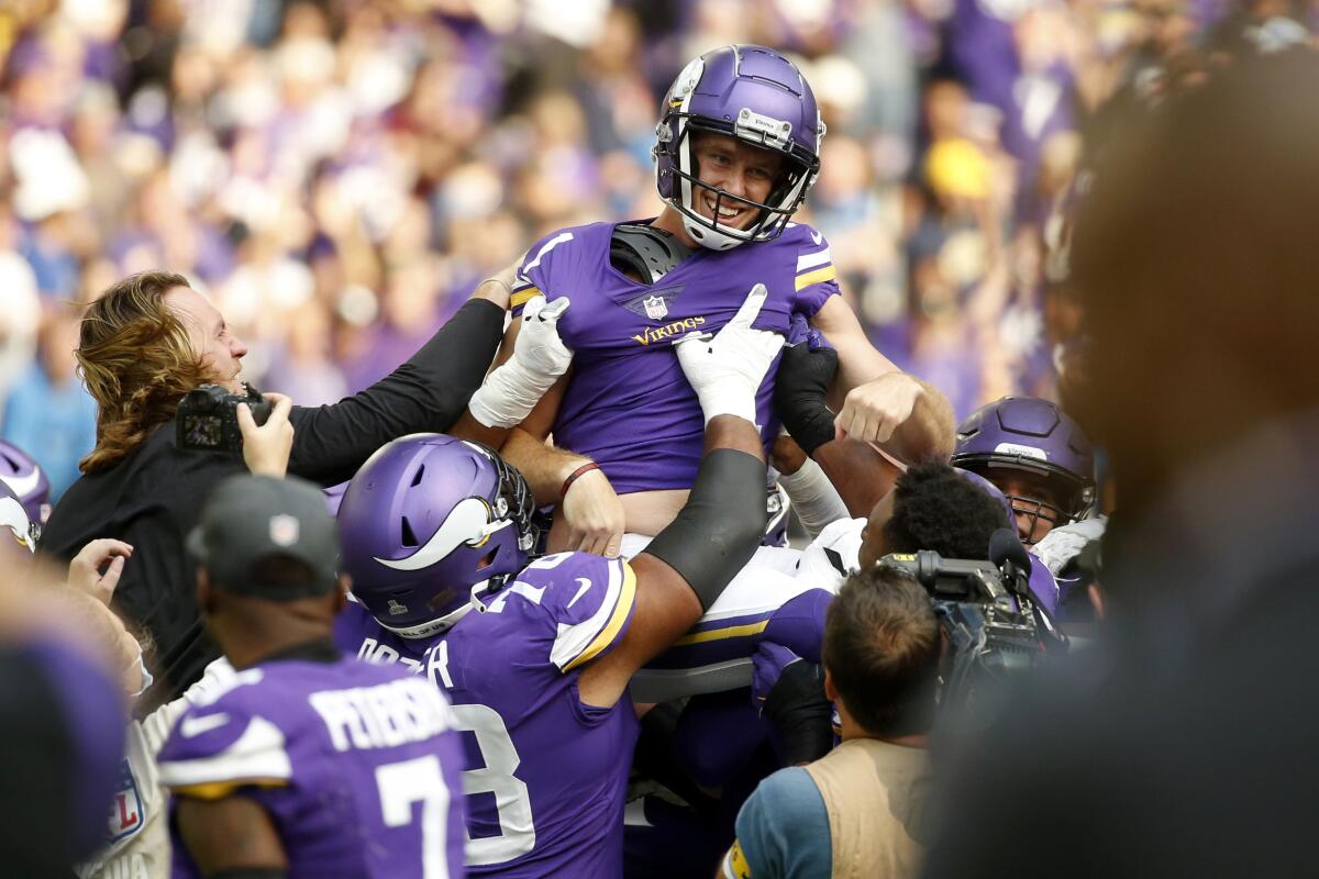 Minnesota Vikings kicker Greg Joseph (1) celebrates with teammates after kicking a 54-yard field goal on the final play of an NFL football game against the Detroit Lions, Sunday, Oct. 10, 2021, in Minneapolis. The Vikings won 19-17. (AP Photo/Bruce Kluckhohn)