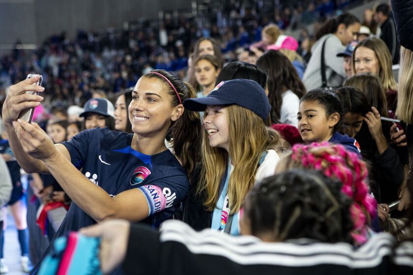 San Diego, CA - March 25: San Diego Wave's Alex Morgan (13) takes selfies with fans after the Wave's win over the Chicago Red Stars during the season opener at Snapdragon Stadium on Saturday, March 25, 2023 in San Diego, CA. (Meg McLaughlin / The San Diego Union-Tribune)