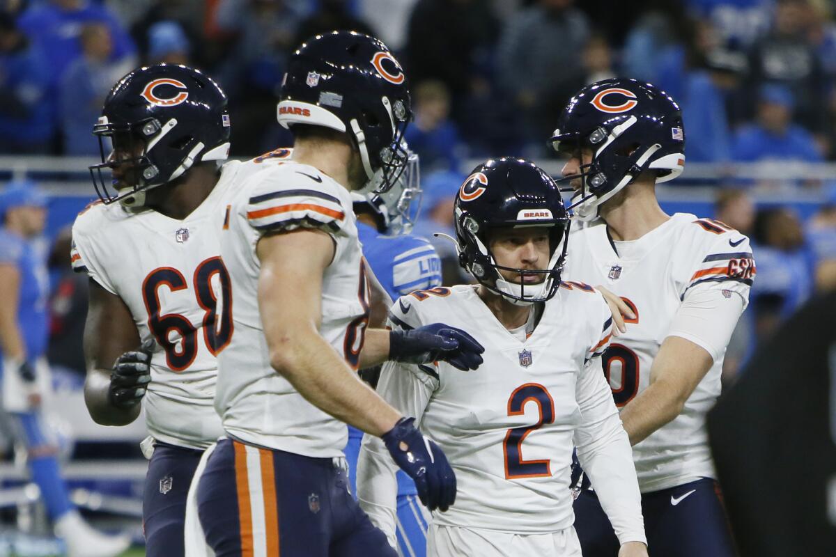 Bears kicker Cairo Santos (2) is surrounded by teammates after kicking the game-winning field goal.